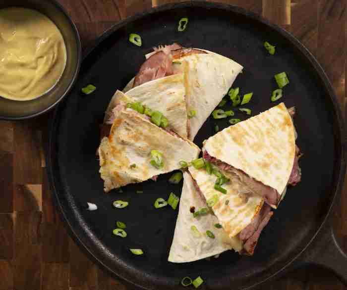 A Cuban quesadilla in a cast iron pan.