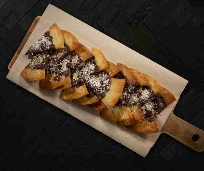 A Tray of Festive Chocolate-Dipped Chips on a cutting board.