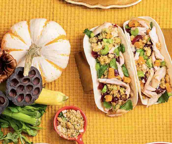 Two Leftover Turkey Tacos next to a white pumpkin on a yellow tablecloth.