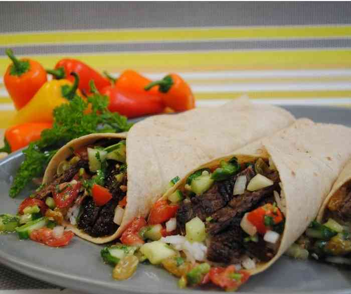 Two Charred steak burritos side by side.