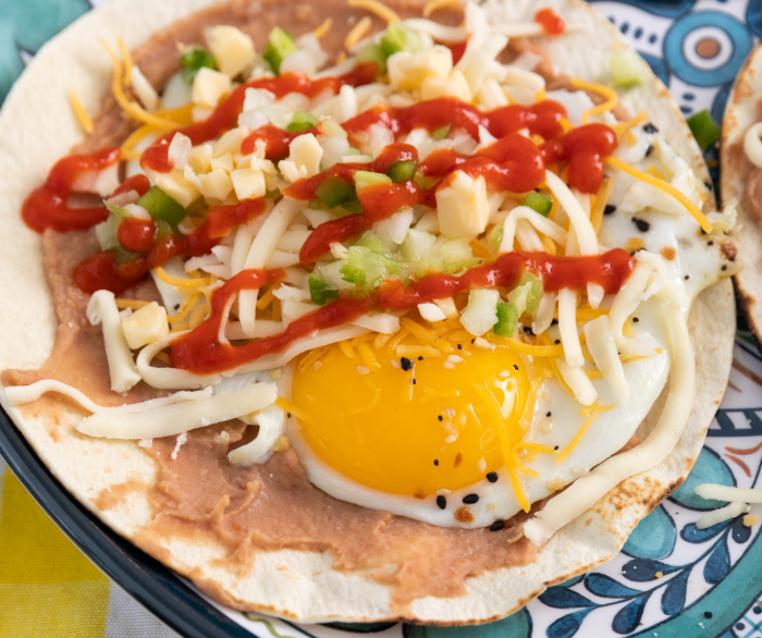 Sunny-Side-Up Breakfast Tostadas on a blue plate.