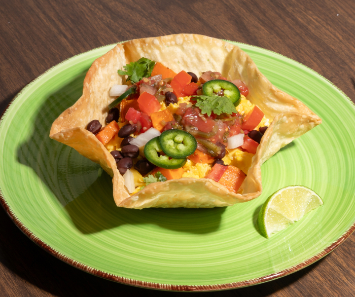 A Sweet Potato Black Bean Breakfast Bowl on a green plate.